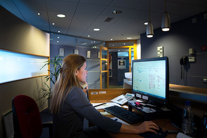 Woman working behind computer screen